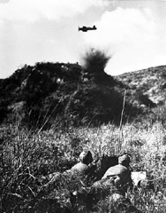 A marine air-observer team guides a marine Corsair