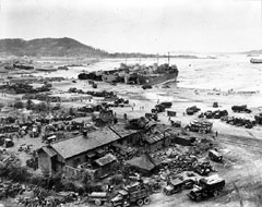 Four LSTs unload on the beach at Inchon