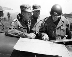 Studying a map at Chunchon airstrip, May, 1951