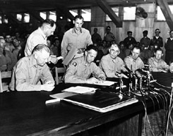 General Mark W. Clark signs the Korean armistice agreement on July 27, 1953