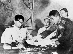 North Korean Premier Kim Il Sung prepares to sign armistice