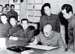 Peng Dehuai signs Korean armistice at Kaesong